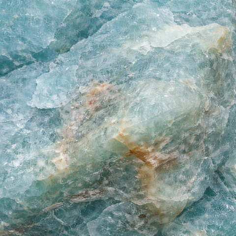 Raw aquamarine crystal on white background