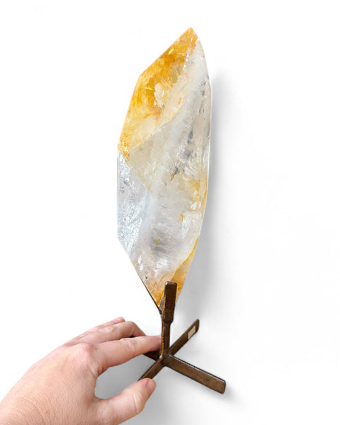 Golden healer quartz crystal on stand