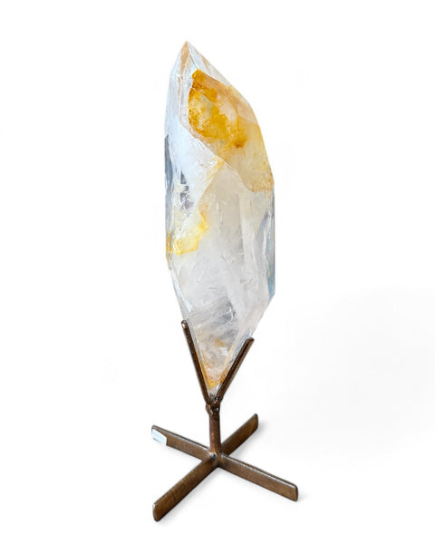 Golden healer quartz crystal on stand