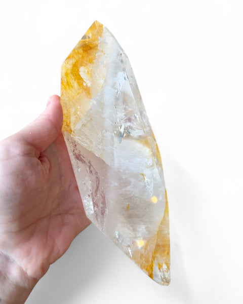 Golden healer quartz crystal on stand
