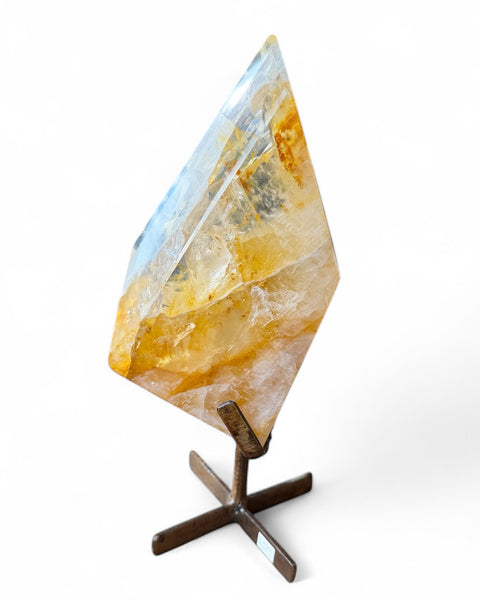 Golden healer quartz crystal on stand