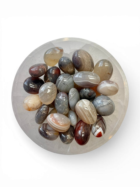 Agate tumble stones in a selenite bowl