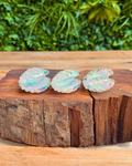 three aura quartz clam shell carvings
