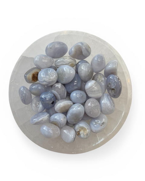 A bowl of blue lace agate tumble stones 
