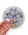 blue lace agate tumble stone in hand