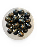 A bowl of blue tigers eye tumble stones