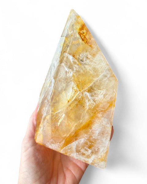 Golden healer quartz crystal on stand