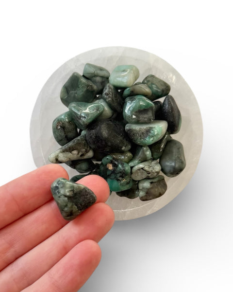 Emerald tumble stone in hand 