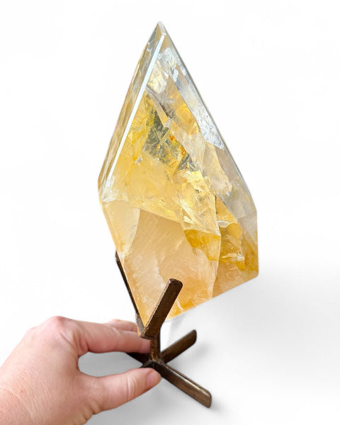 Golden healer quartz crystal on stand