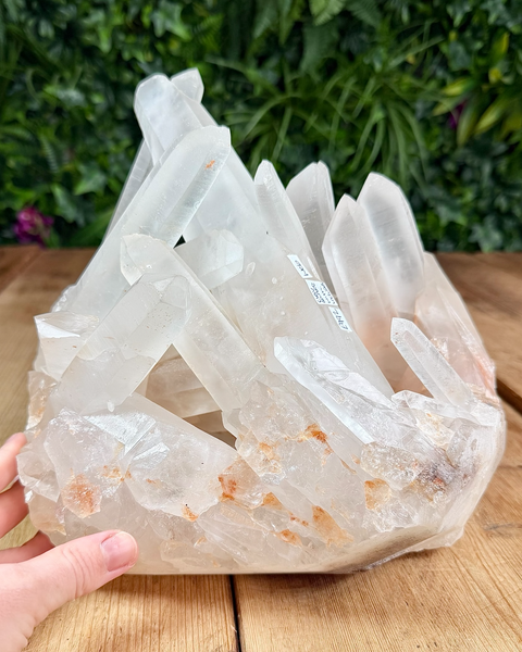 Clear quartz cluster with hematite inclusions
