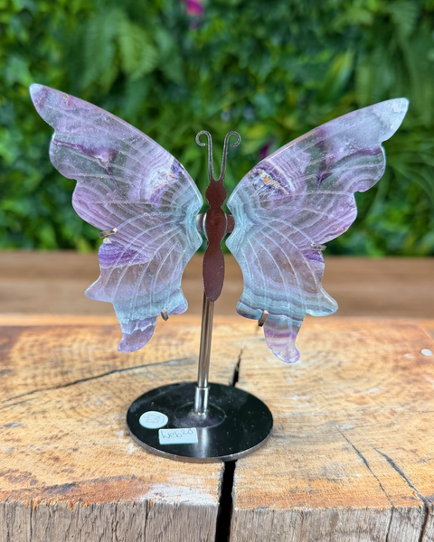 small Decorative butterfly on a stand with a blurred green background