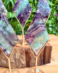 fluorite Geometric crystal sculptures on stands with a natural background