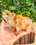 Golden healer quartz elephant carving held in hand