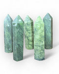 A collection of green jade towers with a matte finish, varying in size.