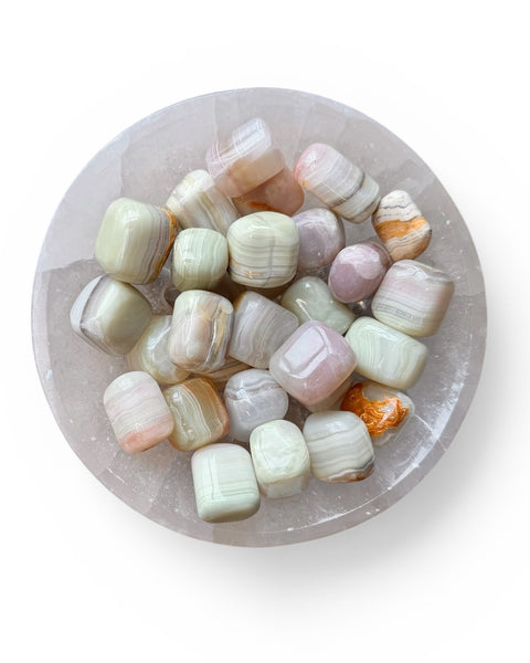 Green onyx tumble stones in a bowl