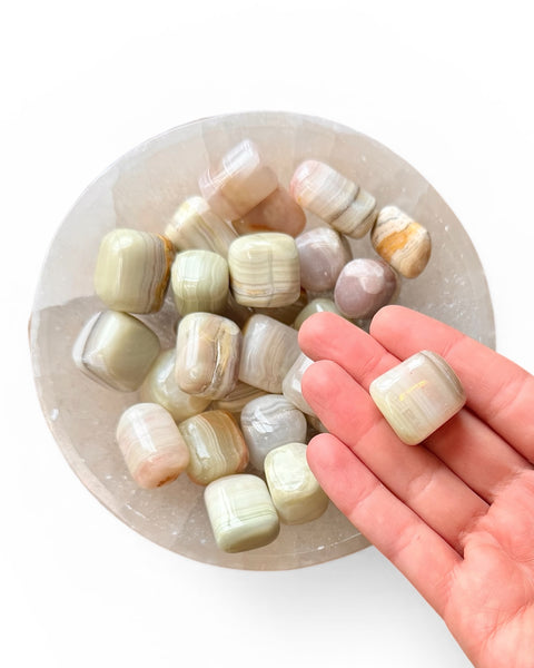 hand holding green onyx tumble stone