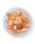 Bowl of honey calcite tumble stones