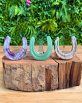 Three horse shoe crystal carvings
