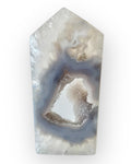 Geode crystal with layered patterns on a white background