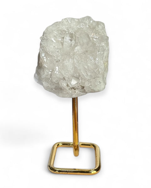 Clear quartz cluster on gold stand