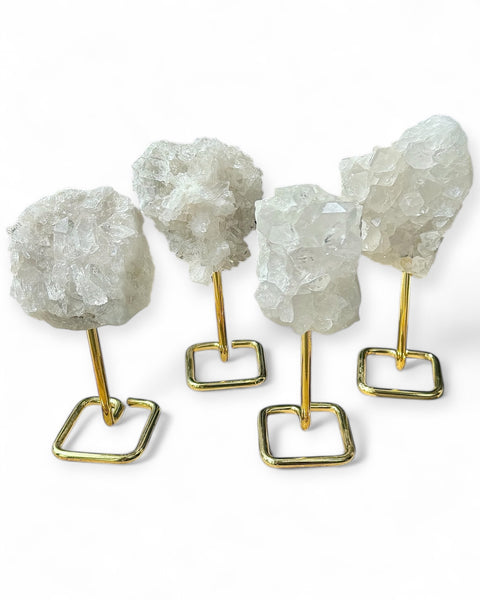 Clear quartz cluster on gold stand