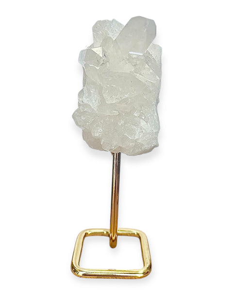 Clear quartz cluster on gold stand