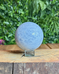 Polished Blue Calcite sphere with soft sky-blue colouring and subtle marbling.