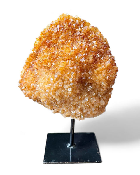 Heat treated citrine crystal on stand