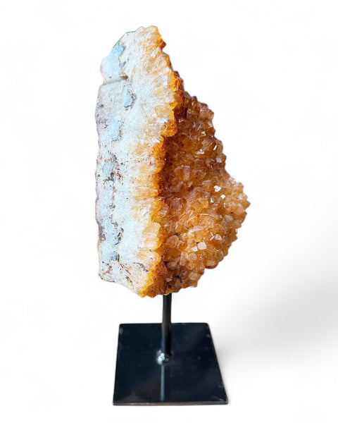 Heat treated citrine crystal on stand