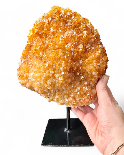 Heat treated citrine crystal on stand