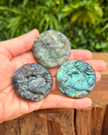 three round labradorite dragon carvings in hand