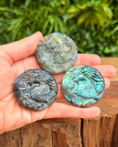 three round labradorite dragon carvings in hand