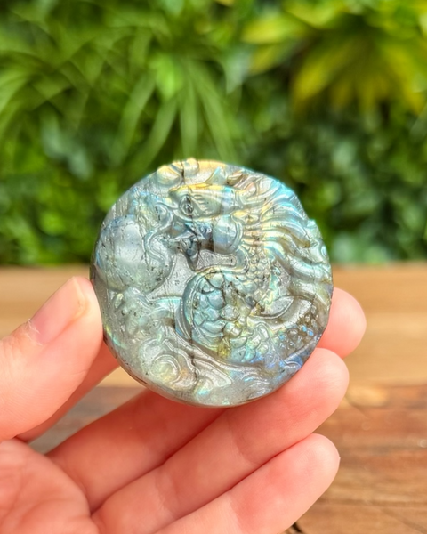 round labradorite dragon carving held in hand