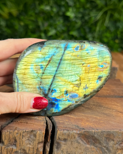 Polished labradorite freeform displaying green and gold flashes