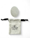 Clear quartz crystal thumb / worry stone with Feel Good Crystals drawstring pouch
