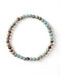 A beaded bracelet made of Shou Shan jade stones, displayed on a white background.