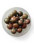 a bowl of unakite tumble stones