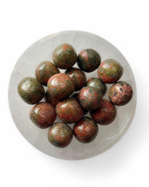 a bowl of unakite tumble stones