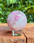 pink purple and which crystal sphere on a stand
