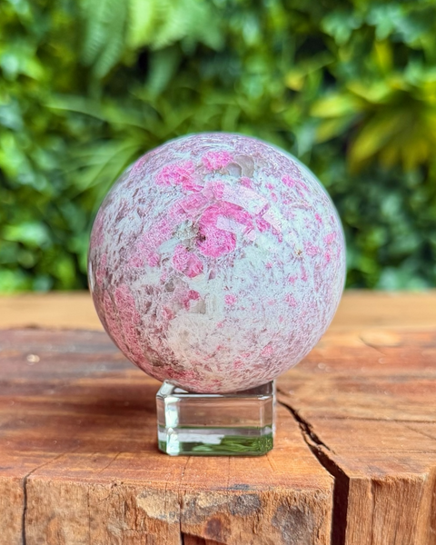 pink purple and which crystal sphere on a stand