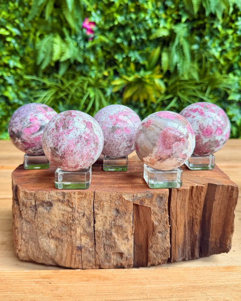 five crystal spheres on a wooden display