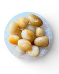 yellow aventurine tumble stones in a dish