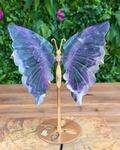 Banded fluorite butterfly carving with purple and green tones on gold stand.