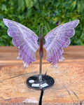 Decorative butterfly sculpture on a stand with a blurred green background
