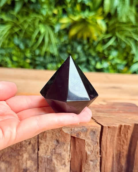 obsidian crystal carved into a gem shape