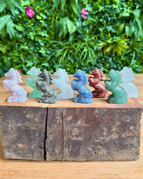 a collection of crystal horse carvings